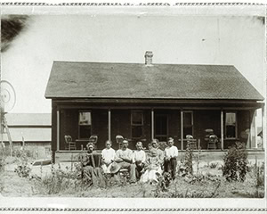 Black and white photo of early Lodi Winegrape Commission building with people in front, circa early 1900s.