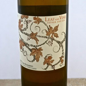 Close-up of a wine bottle label from Lodi Winegrape Commission with grapevine design.