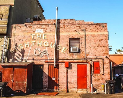 Historic brick building with 'The Lighthouse Cafe' sign in Lodi, California, representing local wine industry history.