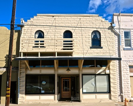 Historic building with stone facade and large windows, representing Lodi Winegrape Commission's presence in the region.