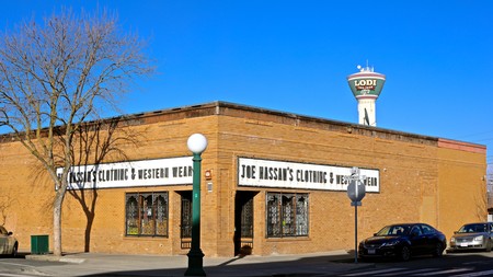 Lodi Winegrape Commission building in Lodi, California, with clear blue sky and a water tower in the background.