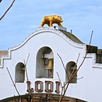 Historic Lodi building with a golden bear statue on top, representing the Lodi Winegrape Commission.