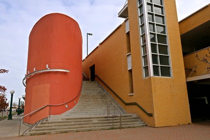 Modern building of the Lodi Winegrape Commission with orange brick and unique cylindrical structure.