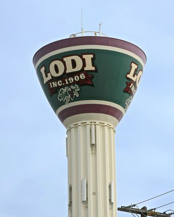 Lodi water tower featuring the Lodi Winegrape Commission logo and branding, representing the region's wine industry.