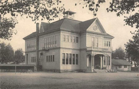 Historic Lodi Winegrape Commission building with Victorian architecture and large windows.