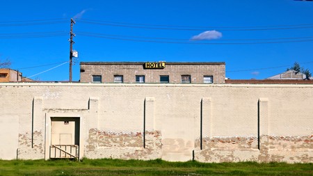 Old hotel building with a yellow sign on top, under a clear blue sky in Lodi, California.
