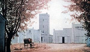 Scenic view of Lodi Winegrape Commission vineyard with historic buildings and autumn trees.