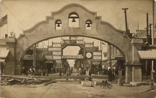 Vintage photo of the historic Lodi Winegrape District entrance with people and buildings.