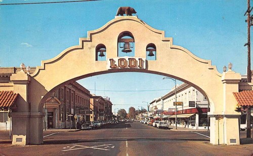 Historic Lodi archway entrance to downtown with shops and streets in the background.