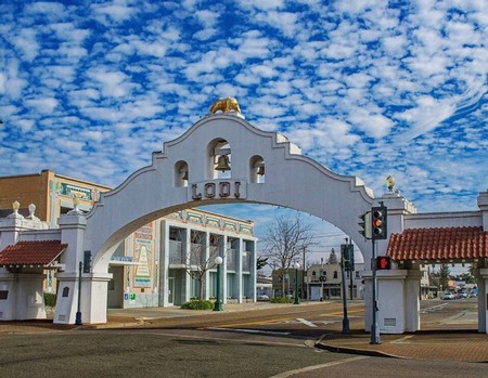 Iconic gateway arch of Lodi Winegrape Commission in California with blue sky and clouds.