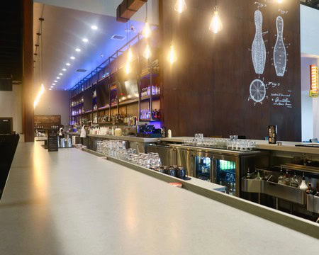 Modern bar interior showcasing wine bottles and brewing diagrams, emphasizing Lodi wine industry.