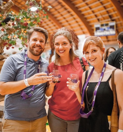 Group of people enjoying wine tasting at Lodi Winegrape Commission event.