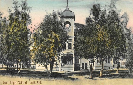Historic Lodi High School building surrounded by trees in Lodi, California.