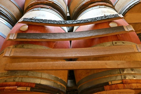 Stacked wine barrels in a winery, showcasing traditional wine aging process in Lodi, California.