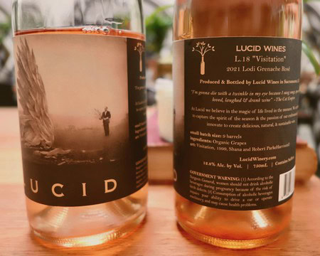 Close-up of a Lodi Grenache wine bottle label and glass with wine, showcasing the wine's details and branding.