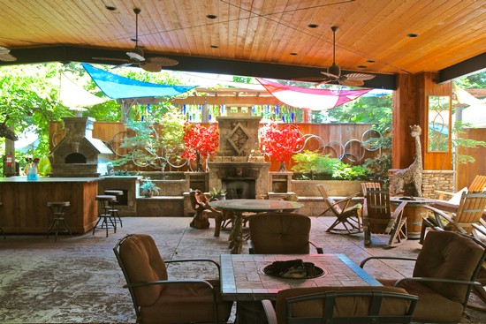 Outdoor patio with seating, fireplace, and colorful umbrellas at Lodi Winegrape Commission.
