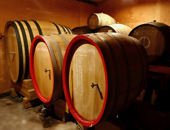 Wine barrels in a cellar representing Lodi Winegrape Commission's wine production.
