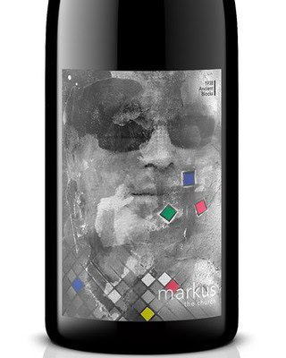 Close-up of Markus the Churro wine bottle label with abstract face design and colorful geometric accents.