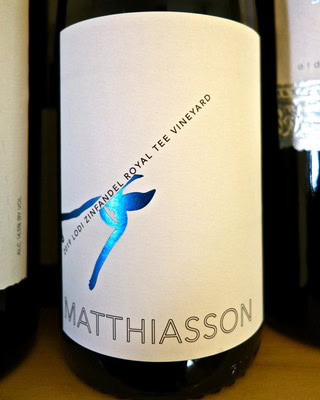 Close-up of a wine bottle label from Lodi Winegrape Commission, featuring a blue bird logo and the name Mathiasson.