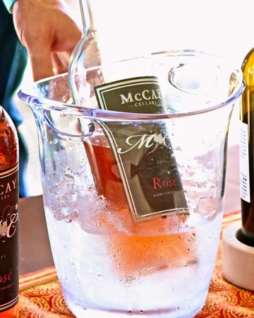 Bottle of McCay Cellars Rosé wine chilling in ice bucket for wine tasting event.