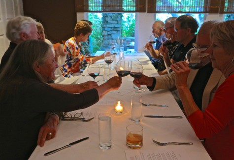 Group of people enjoying wine tasting at a dinner event, celebrating Lodi wine culture and community.