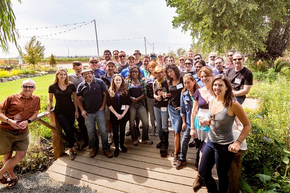Group of people at Lodi Winegrape Commission outdoor event in sunny vineyard setting.
