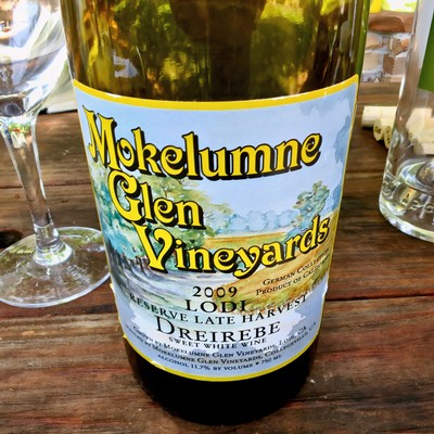 Close-up of Mokelumne Glen Vineyards 2009 Lodi wine bottle on a wooden table.