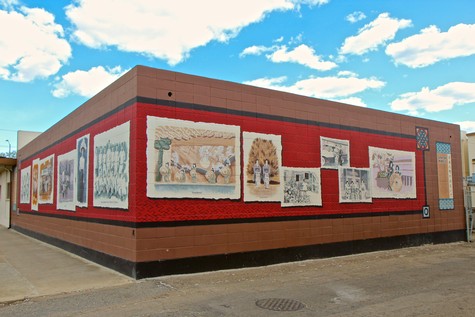 Outdoor mural showcasing Lodi winegrape history and vineyard scenes at the Lodi Winegrape Commission.