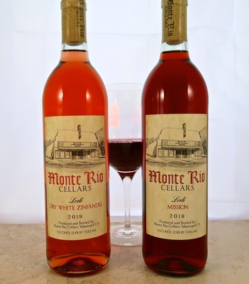 Two bottles of rosé wine from Monte Rio Cellars with a glass of wine in between, on a white background.
