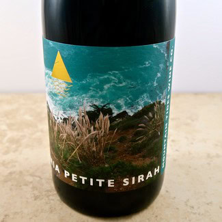 Close-up of a wine bottle label featuring Lodi Winegrape Commission branding and scenic vineyard imagery.