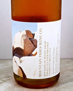 Close-up of a wine bottle label from Lodi Winegrape Commission showcasing rocks and vineyard details.