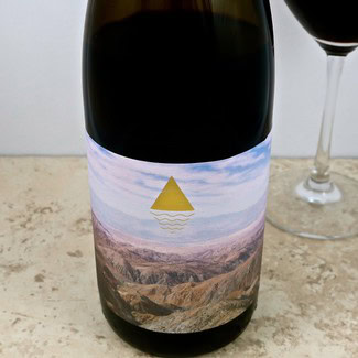 Wine bottle with scenic landscape label from Lodi Winegrape Commission, California wine region.