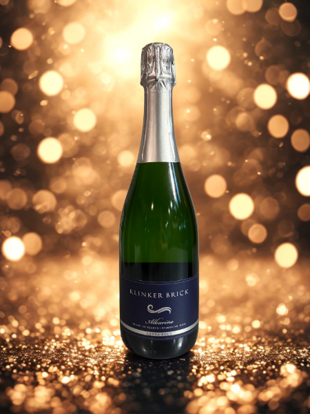 Elegant sparkling wine bottle from Lodi Winegrape Commission with a festive background.