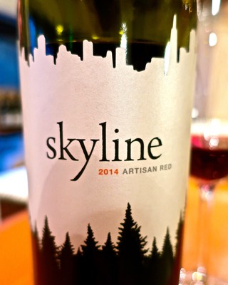 Close-up of Skyline 2014 Artisan Red wine bottle label with cityscape silhouette.
