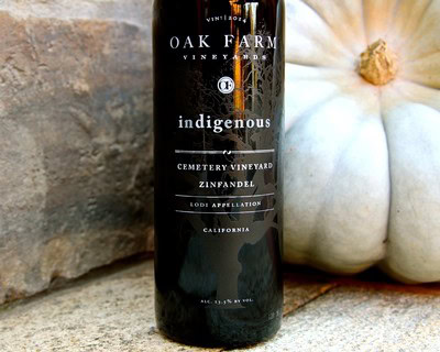 Lodi Winegrape Commission bottle of Indigenous Zinfandel wine with pumpkins in background.