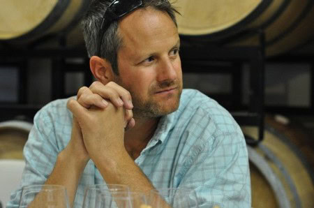Man tasting wine at Lodi Winegrape Commission event, showcasing local wine industry and viticulture.