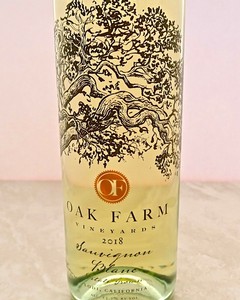 Close-up of a wine bottle from Oak Farm Vineyards with detailed label and logo, showcasing Lodi wine region.
