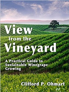 Scenic view of lush vineyard rows with a tree, under a partly cloudy sky, promoting sustainable wine grape growing.