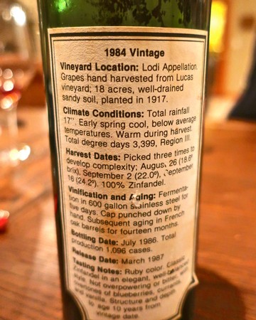 Close-up of a vintage 1984 Lodi wine bottle label with vineyard and harvest details.