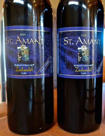 Two bottles of St. Amant Zinfandel wine from Mariani Vineyard in Lodi, California, vintage 2001 and 2002.