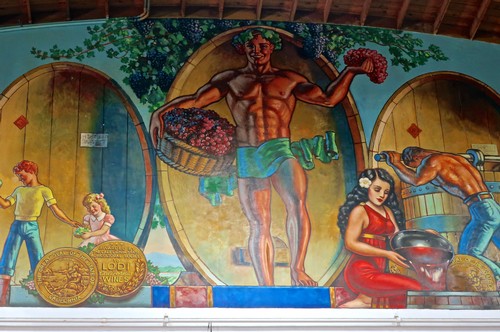 Colorful mural depicting grape harvest and wine production at Lodi Winegrape Commission.