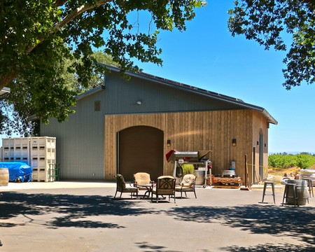 Lodi Winegrape Commission building with outdoor seating and vineyard in the background.