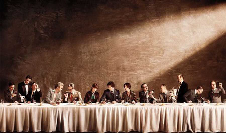 Group of people enjoying a wine tasting event at a long table in Lodi, California.
