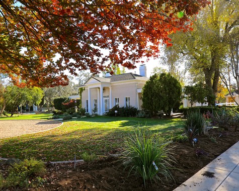 Lodi Winegrape Commission building surrounded by trees and landscaped garden in Lodi, California.