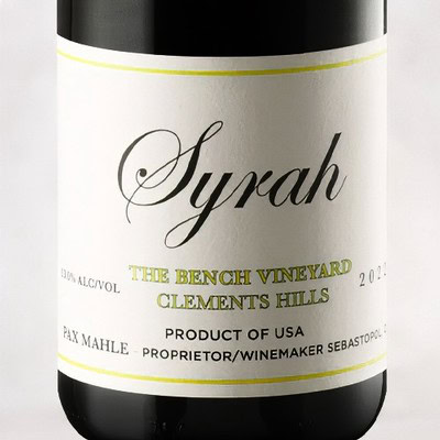 Close-up of Syrah wine bottle label from The Bench Vineyard in Clarksburg, California, showing vintage and producer details.