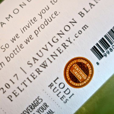Close-up of Lodi Winegrape Commission seal on wine label emphasizing quality and authenticity.