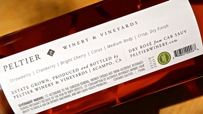 Close-up of a wine bottle label from Lodi Winegrape Commission showcasing estate-grown wine details.