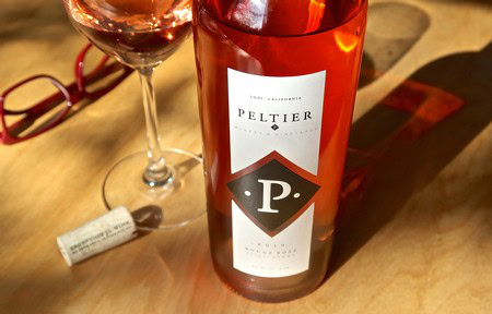 Bottle of Peltier wine from Lodi Winegrape Commission with a glass of rosé wine.