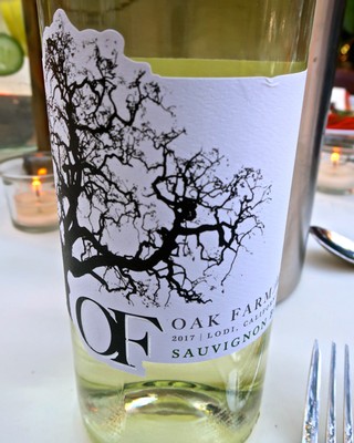 Lodi Oak Farm Sauvignon Blanc wine bottle with tree branch label design, 2017 vintage, perfect for wine enthusiasts.