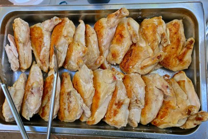 Close-up of grilled chicken wings on a tray, perfect for wine pairing at Lodi Winegrape Commission event.